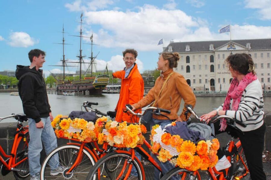 Amsterdam: Cheese Tasting, Windmill & Countryside Bike Tour - City warm-up: canals, Het Scheepvaartmuseum, and the De Gooyer windmill