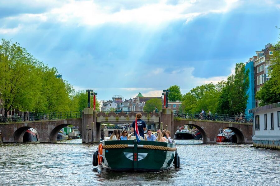 Amsterdam: The Newest Canal Cruise with Drink Option - Skipper stories in English, plus an 8-language QR booklet